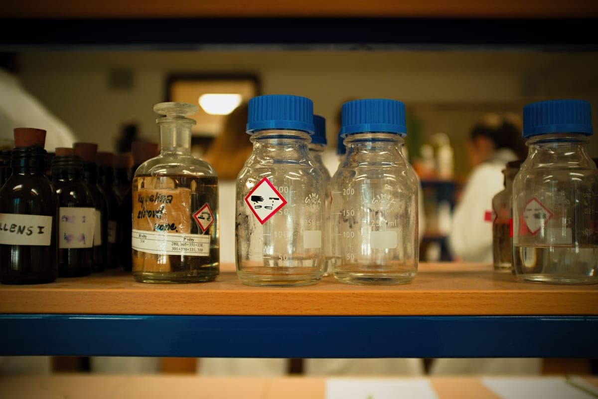 Bottles of aquarium bacteria supplement beside a tank