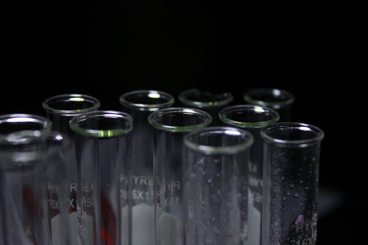 An aquarium liquid test kit with reagent bottles and glass test tubes