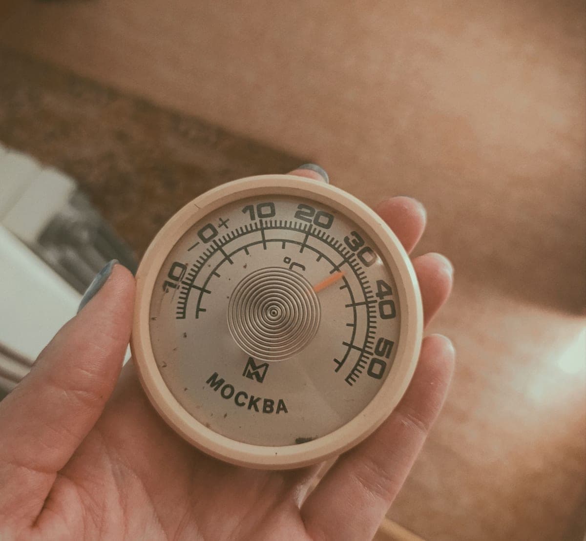 A thermometer showing a water temperature reading