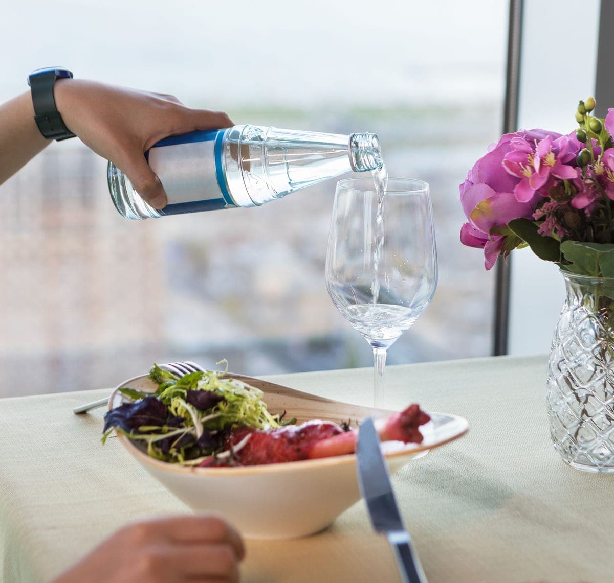 Water being poured from a bottle into a glass