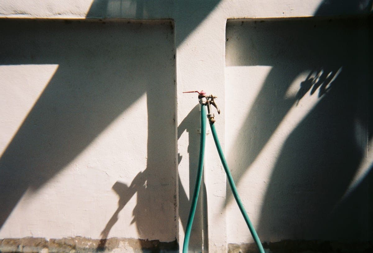 A hose-fed aquarium water changer attached to a faucet